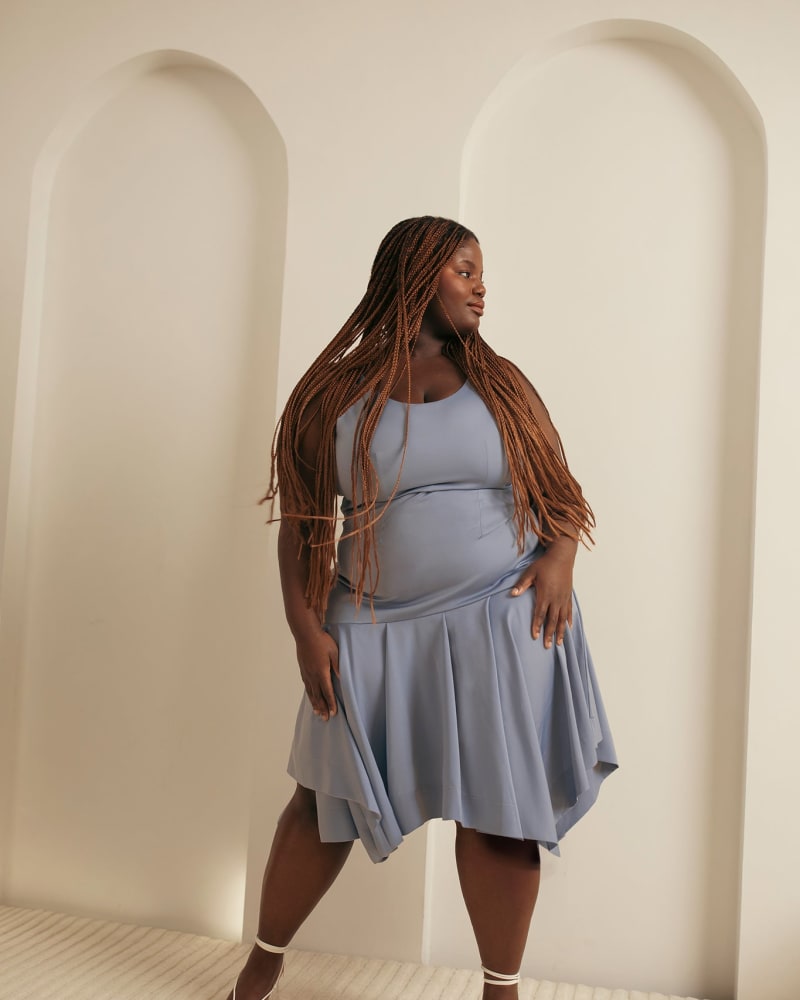 Front of a model wearing a size 2X Pleated Hem Dress in Blue by Hilary MacMillan. | dia_product_style_image_id:358556
